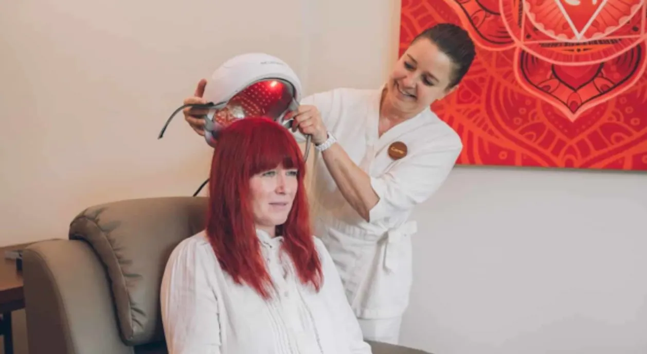 Kamalaya cognative health house woman with red light therapy helmet